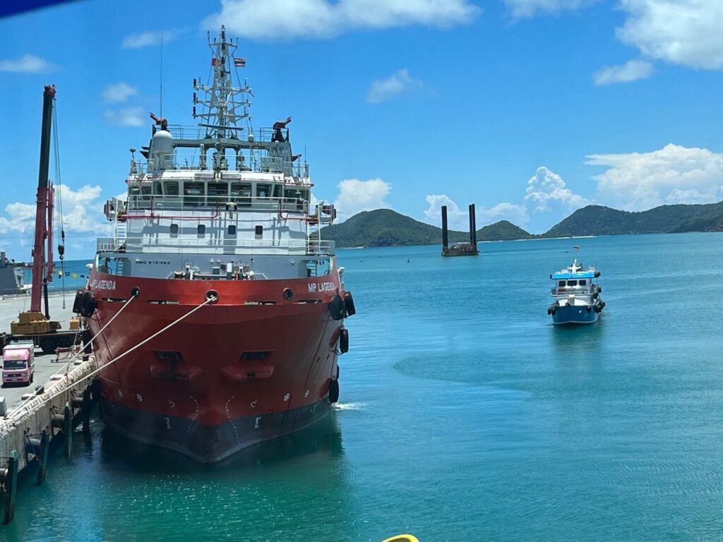 Offshore supply vessel alongside the jetty with islands behind