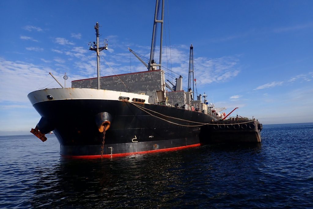 Cargo ship at anchor ready for an in-water survey