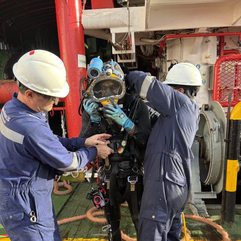Thai Subsea divers preparing a dive helmet offshore