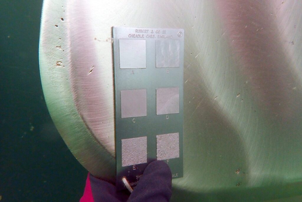 Rubert comparator gauge held against a polished propeller blade