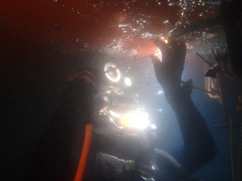 Diver lights during underwater repair work