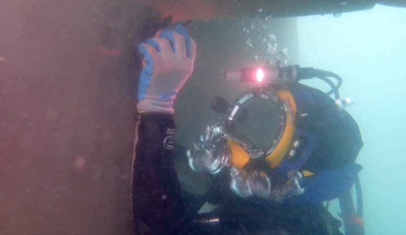 Thai Subsea diver with helmet camera inspecting a hull